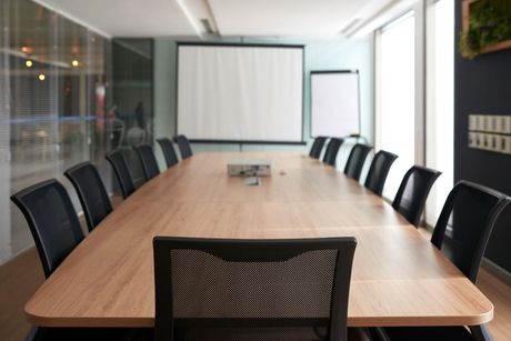 Sala de reuniones profesional moderna en Madrid con mesa ejecutiva, tecnología integrada y ambiente corporativo